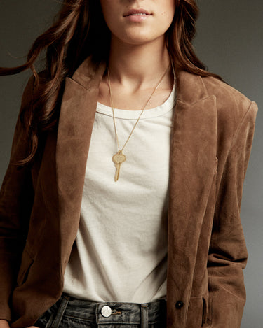 Woman wearing a key on a gold chain