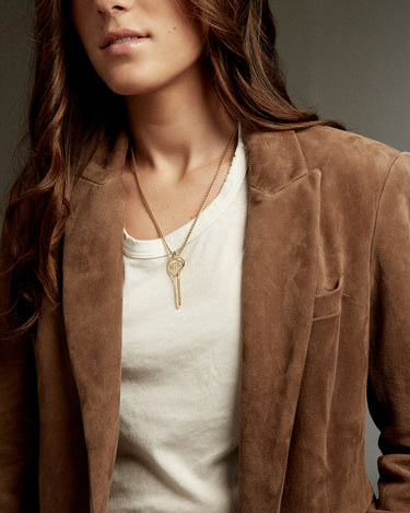 Woman wearing a key on a gold chain