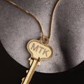 Key with MTK on a gold chain