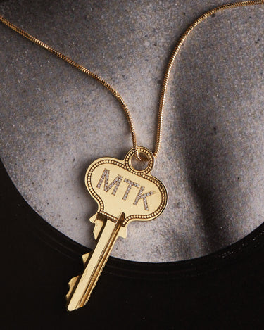 Key with MTK on a gold chain