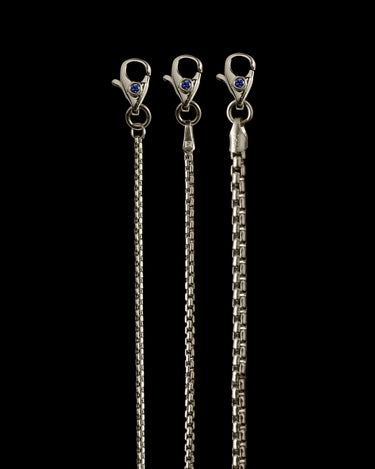 Three white gold chain necklaces with clasp ends