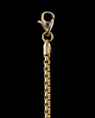 Close-up of a gold chain with a clasp
