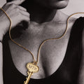 Woman wearing a key on a gold chain