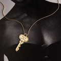 Woman wearing a key on a gold chain