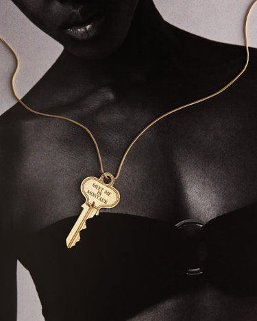 Woman wearing a key on a gold chain