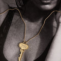 Woman wearing a key on a gold chain