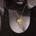 Woman wearing a key on a gold chain