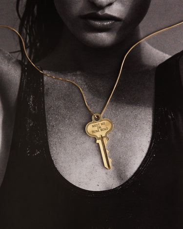 Woman wearing a key on a gold chain