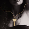 Woman wearing a key on a gold chain