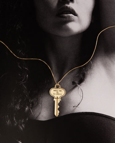 Woman wearing a key on a gold chain