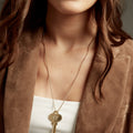 Woman wearing a key on a long length chain