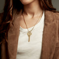 Woman wearing a key on a medium length chain