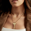 Woman wearing a key on a short length chain