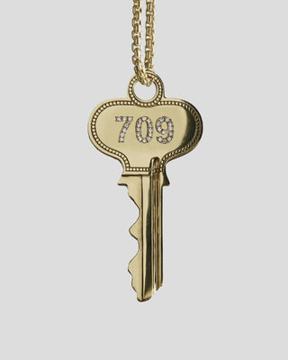 Gold key pendant spinning on a necklace